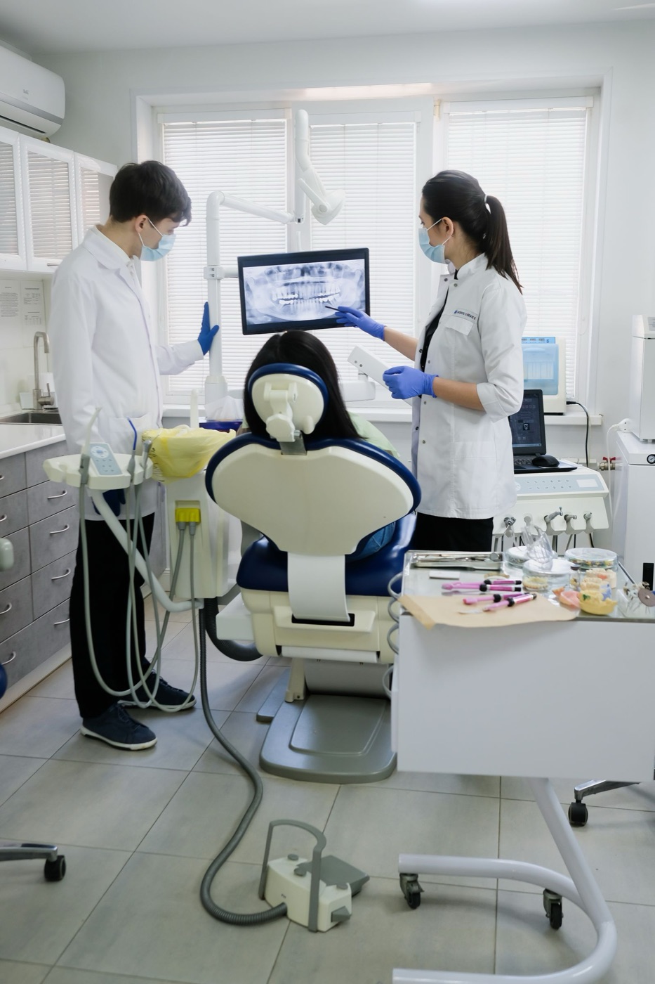 Dental team treating a patient in a modern clinic
